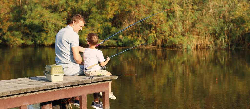 Father and son looking at each other while fishing